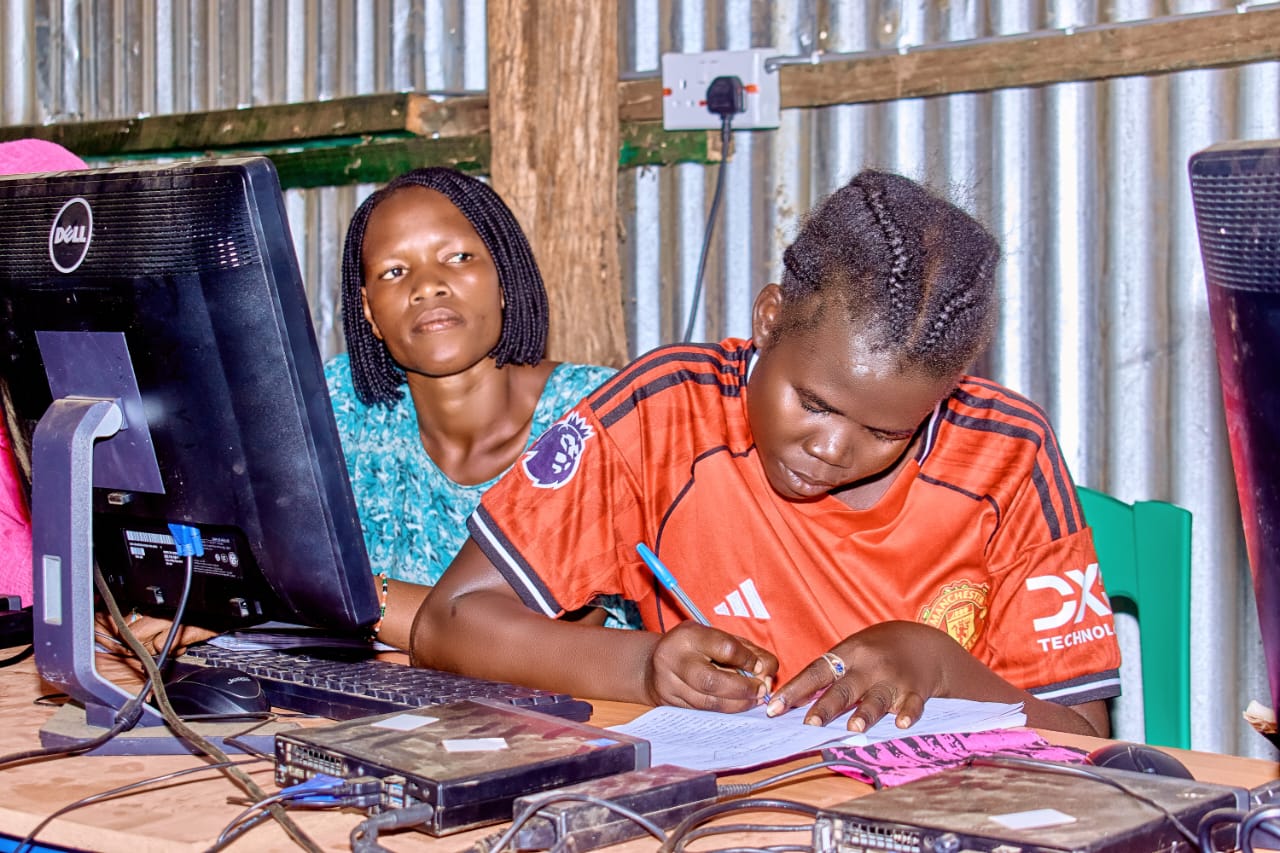 Two young women learning digital skills at ISEC